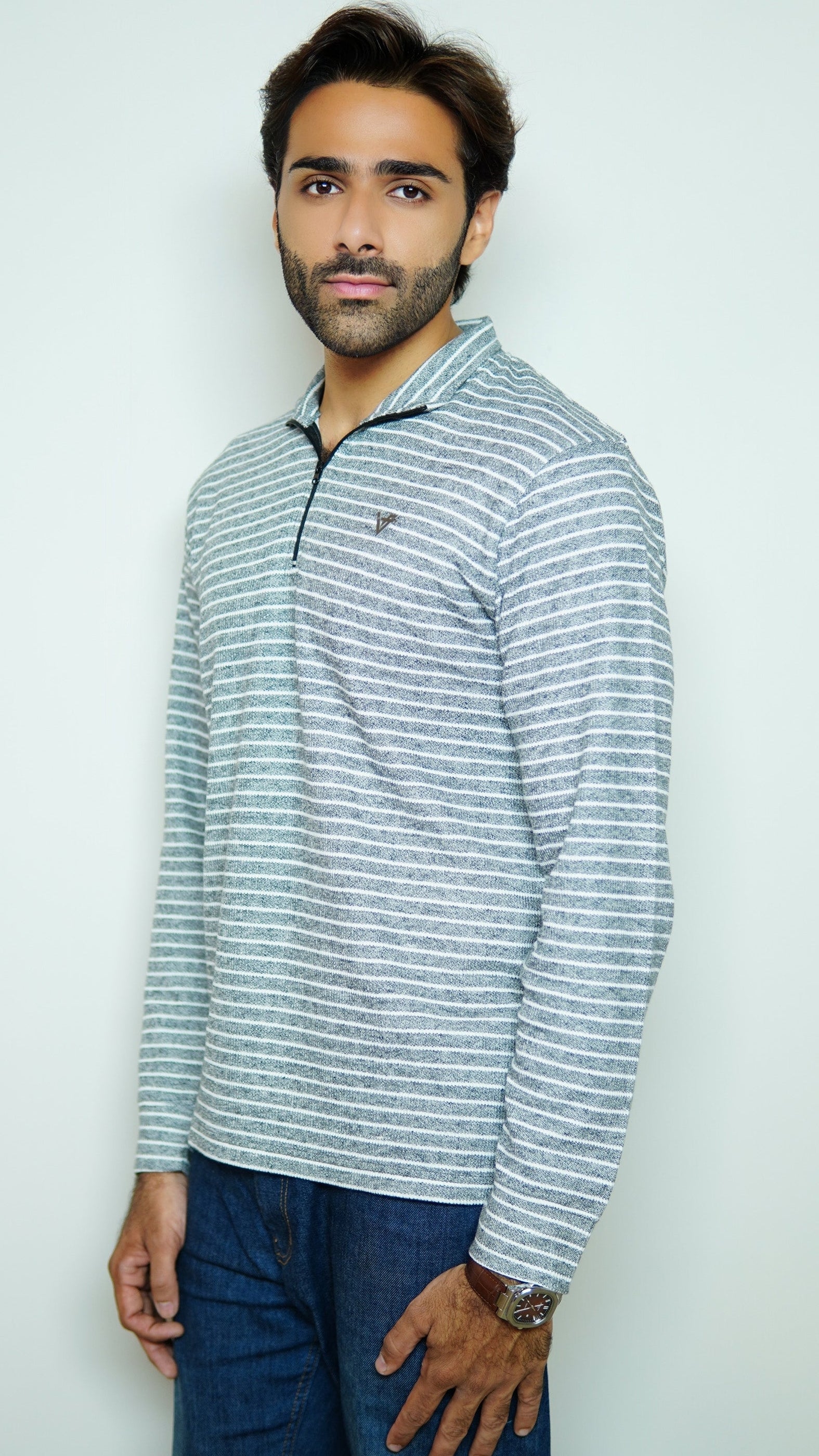 Man wearing a striped long-sleeve shirt against a plain background