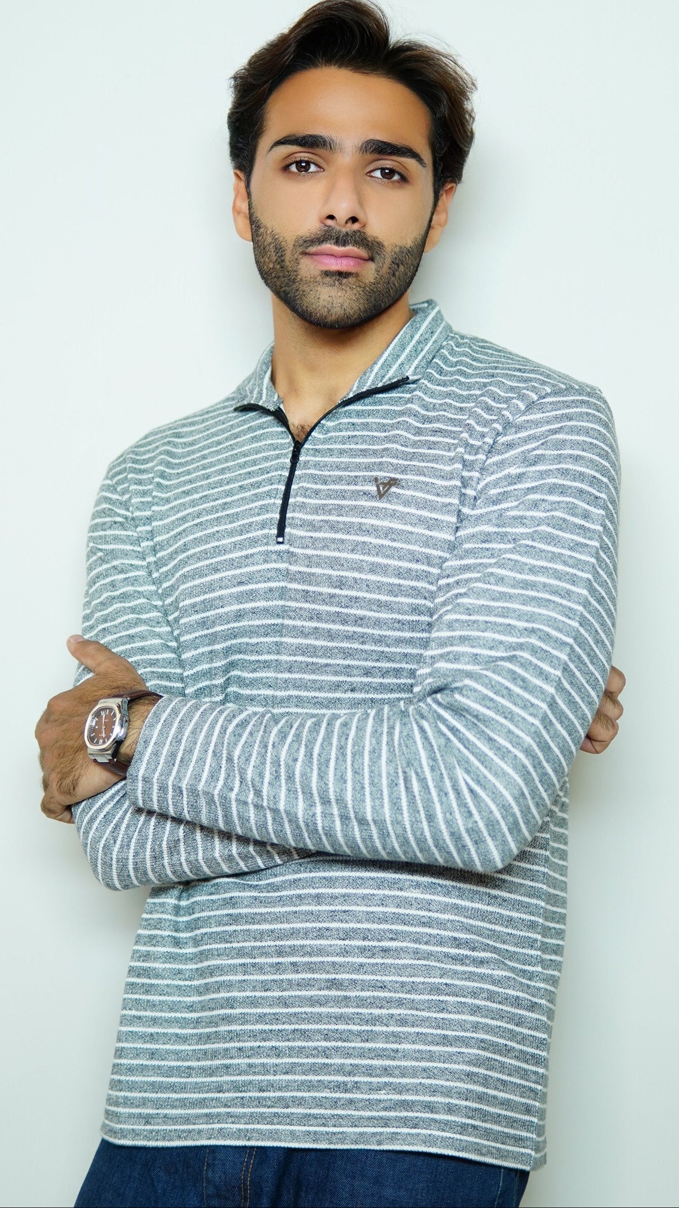 Man wearing a striped long-sleeve shirt against a white background