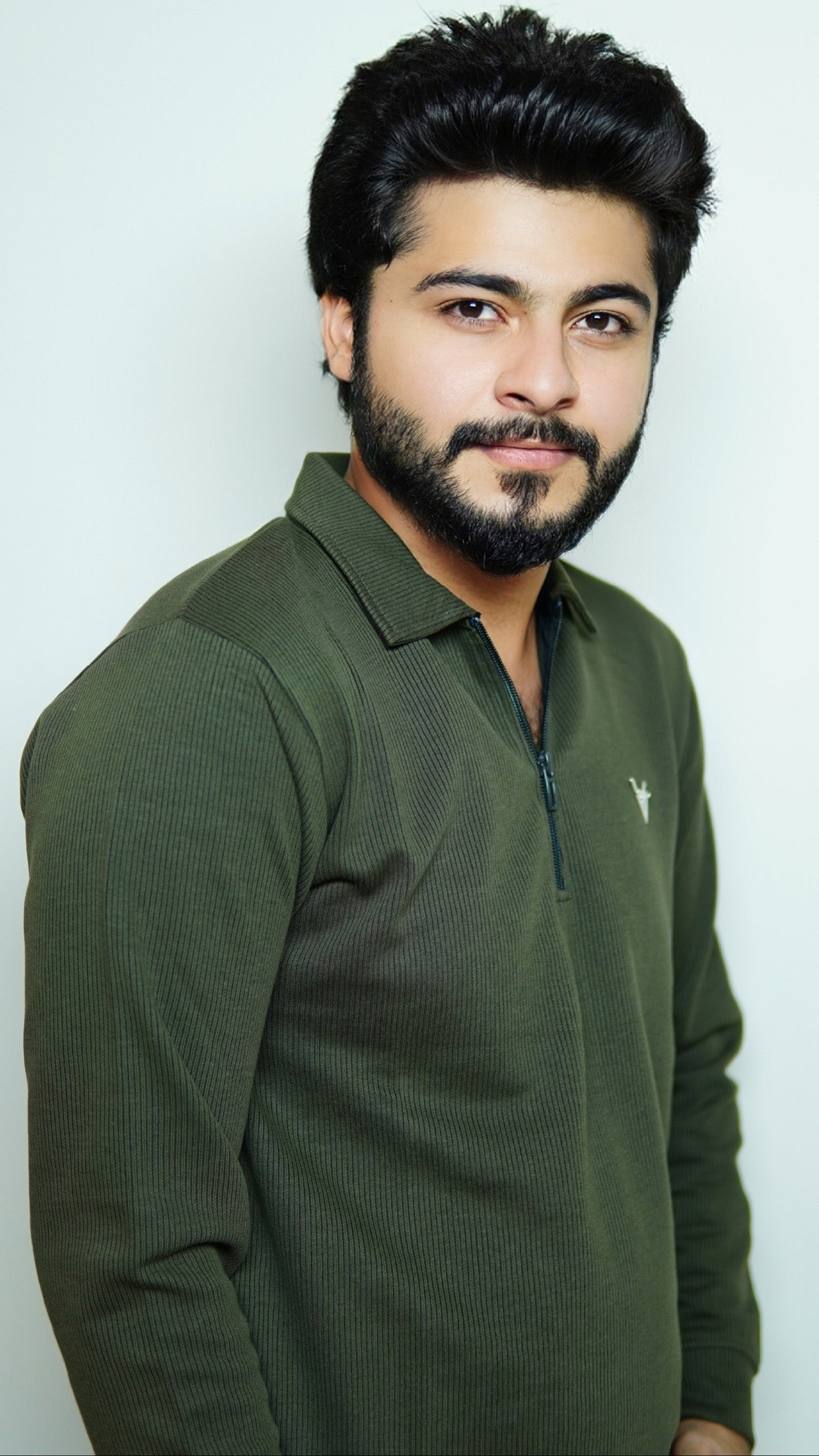 Man wearing a green polo shirt against a white background